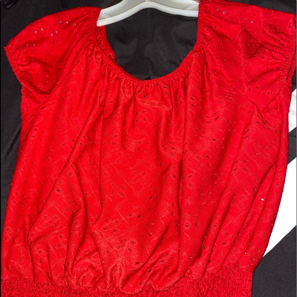 Red top with intentional holes.